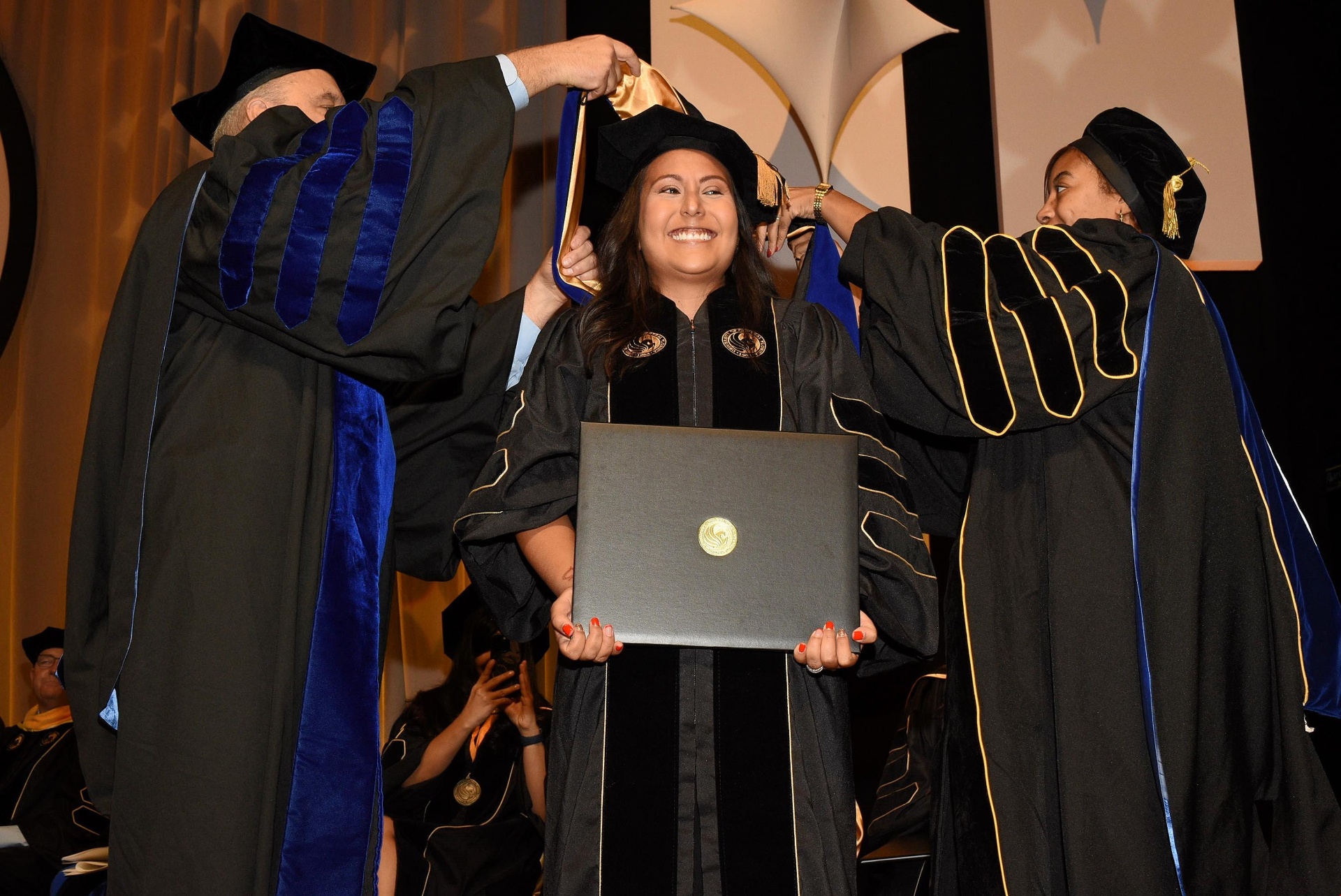 Dr. Ortega being hooded at her UCF doctoral ceremony